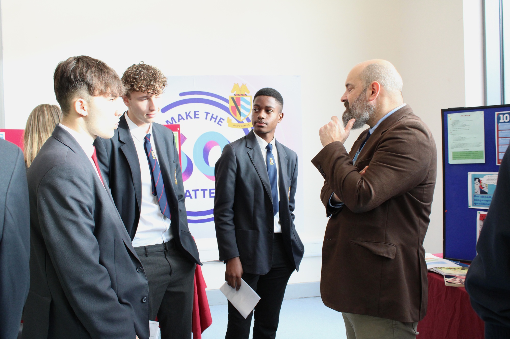 Photo of teachers discussing their subject with students