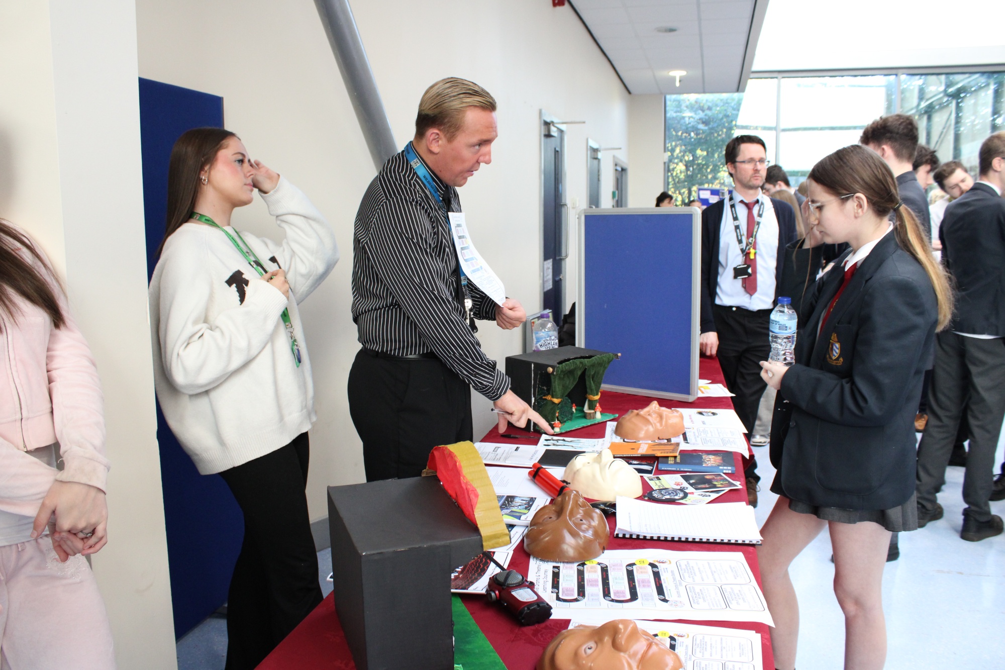 Photo of teachers discussing their subject with students