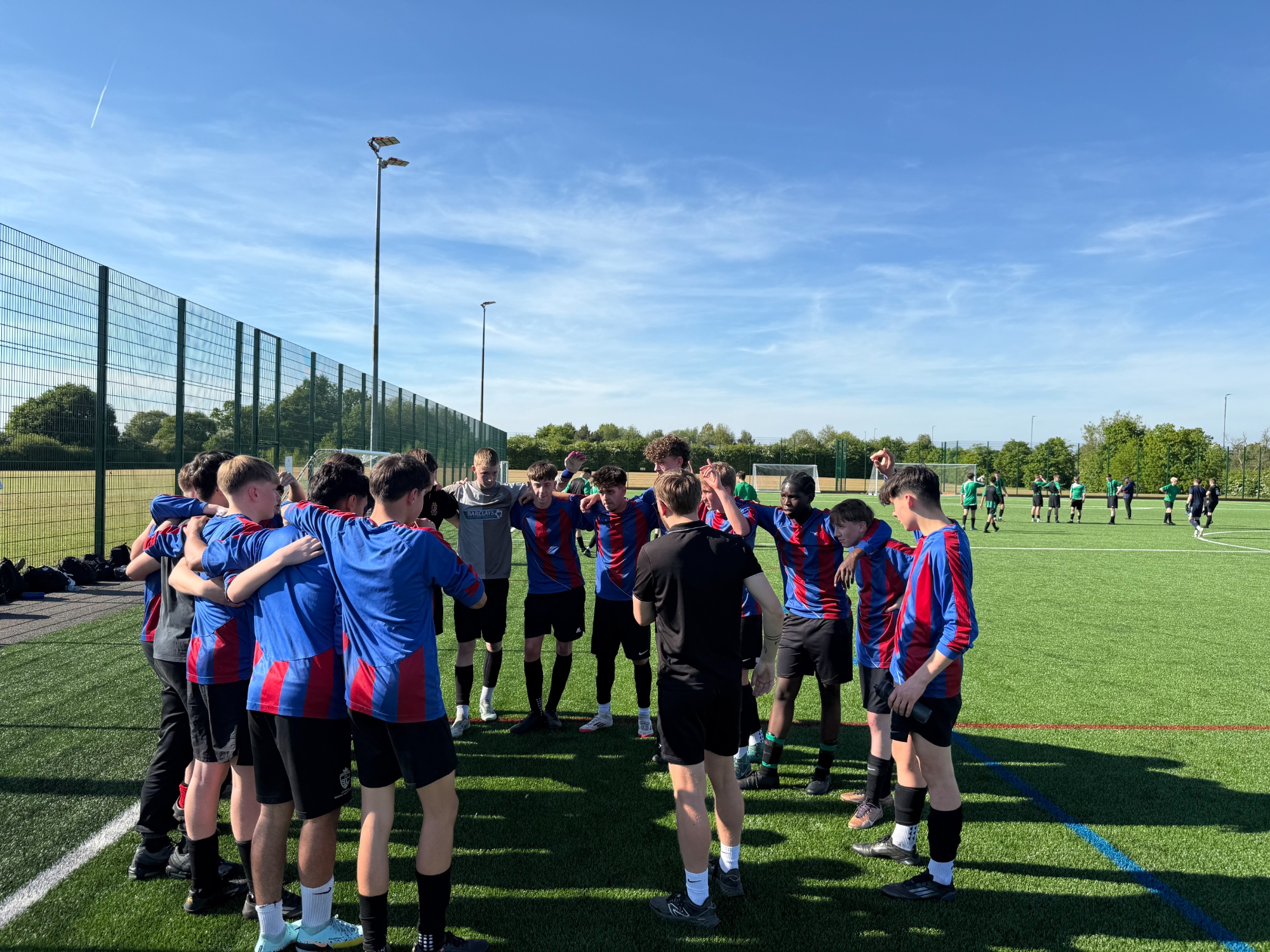Photo of boys football team in a huddle