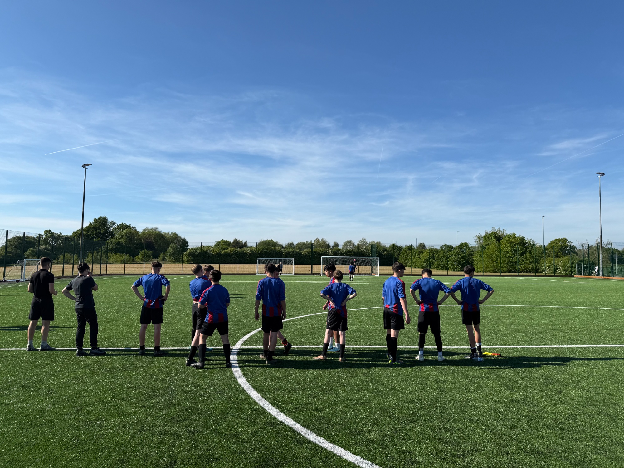 Photo of boys football team on pitch - backs to camera